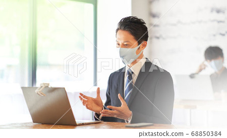 Man in suit making a video call 68850384