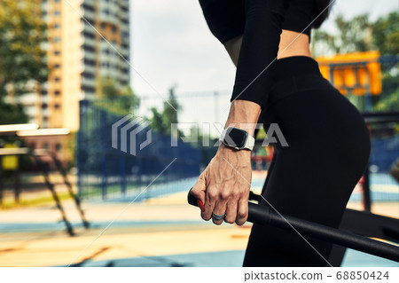 Photo of young european woman on a street workout in sports park on sunny day. Concept of training outdoor. Photo of young european woman on a street workout in sports park on sunny day. Concept of training outdoor. 68850424