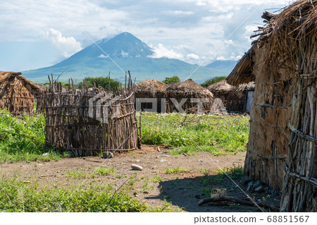 Traditional Maasai Village with Clay Round Huts in Engare Sero area near Lake Natron and Ol Doinyo Lengai volcano in Tanzania, Africa Traditional Maasai Village with Clay Round Huts in Engare Sero area near Lake Natron and Ol Doinyo Lengai volcano in Tanzania, Africa 68851567