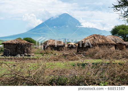 Traditional Maasai Village with Clay Round Huts in Engare Sero area near Lake Natron and Ol Doinyo Lengai volcano in Tanzania, Africa 68851587