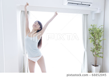 A woman standing up and stretching A woman standing up and stretching 68852045