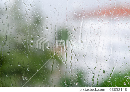 Raindrops hitting on the window glass Raindrops hitting on the window glass 68852148