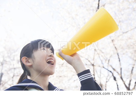 Female junior high school student shouting with a megaphone Female junior high school student shouting with a megaphone 68852797