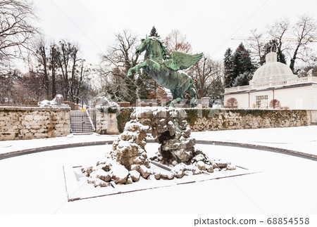 A mid winter view of a statue in Mirabell Gardens in Salzburg, Austria. 68854558