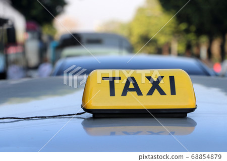 Taxi light sign or cab sign in yellow color with black text on the car roof Taxi light sign or cab sign in yellow color with black text on the car roof 68854879