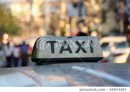 Taxi light sign or cab sign in drab white color and black text on the car roof Taxi light sign or cab sign in drab white color and black text on the car roof 68854881