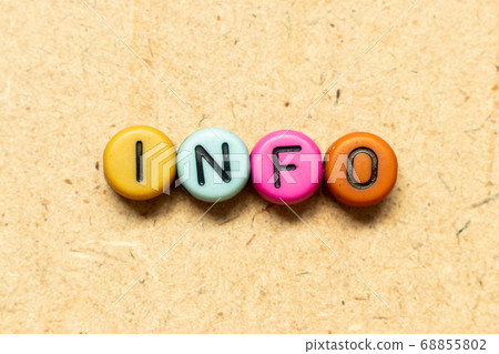 Round color bead with black letter in word info on wood background Round color bead with black letter in word info on wood background 68855802
