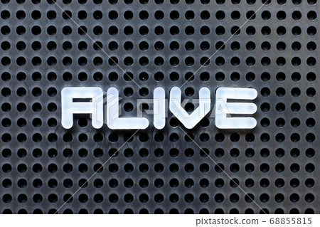White color alphabet with word alive on black pegboard background White color alphabet with word alive on black pegboard background 68855815