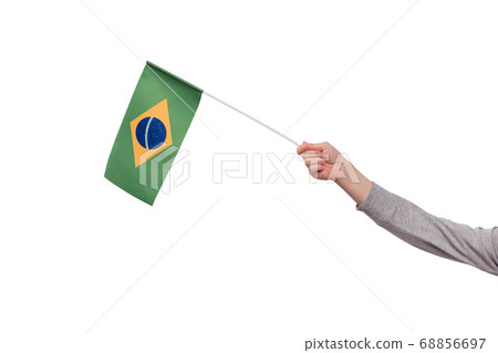 Hand holding Brazil flag isolated on white Hand holding Brazil flag isolated on white 68856697