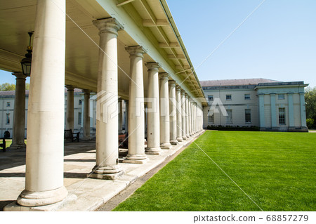 在倫敦格林威治公園（London Greenwich Park）上，一座歷史悠久的白牆石建築，大通道襯砌著石柱 68857279
