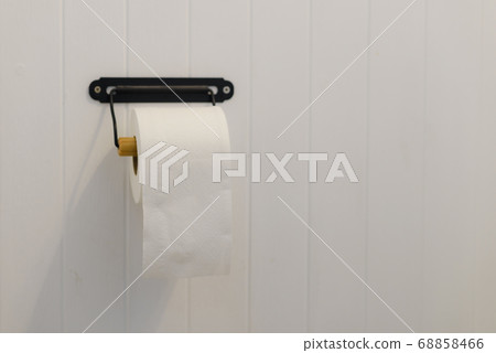soft toilet paper roll on white wall in bathroom with copy space soft toilet paper roll on white wall in bathroom with copy space 68858466