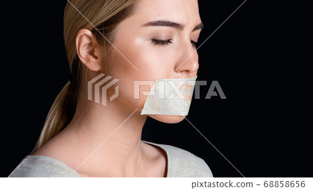 Upset woman with closed eyes and sealed mouth with tape Upset woman with closed eyes and sealed mouth with tape 68858656