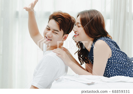 Happy couple in bed 68859331