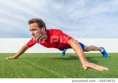 Wide grip pushup push-up variation advanced chest exercise demonstration by male trainer athlete man training at outdoor gym Wide grip pushup push-up variation advanced chest exercise demonstration by male trainer athlete man training at outdoor gym 68859610