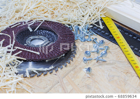 Carpenter tools on wooden table with sawdust. 68859634