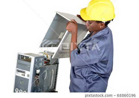 Young computer maintenance technician opens a Young computer maintenance technician opens a 68860196