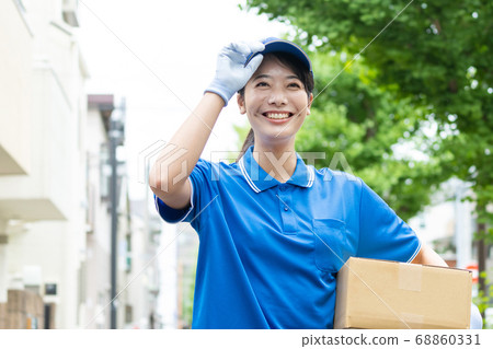Courier young female driver delivering luggage 68860331