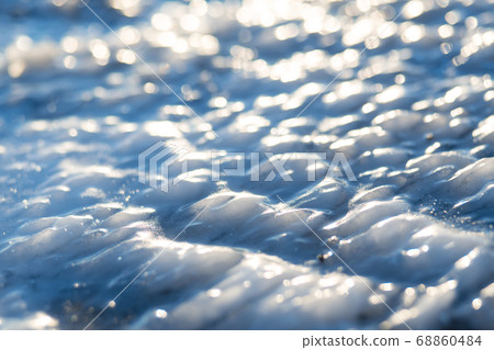 Road covered with ice in the headlights. 68860484