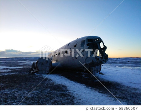 The wreckage of an abandoned DC 3 plane on a black The wreckage of an abandoned DC 3 plane on a black 68860507