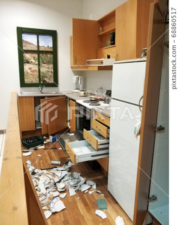 A mess in the kitchen, broken dishes, open A mess in the kitchen, broken dishes, open 68860517