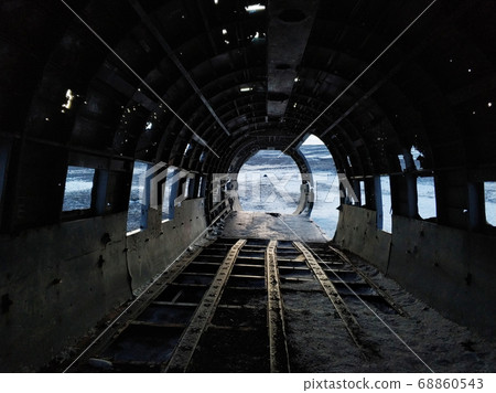 The wreckage of an abandoned DC 3 plane on a black The wreckage of an abandoned DC 3 plane on a black 68860543
