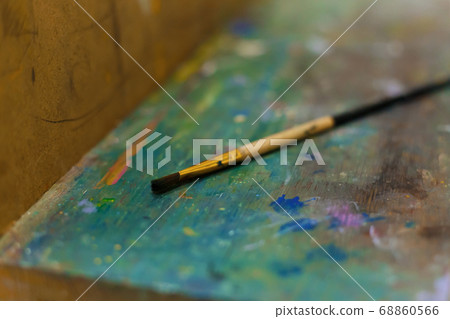 Brushes on an easel stained with paints in the Brushes on an easel stained with paints in the 68860566
