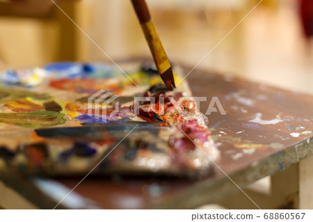 Close-up of an easel with paints, the artist Close-up of an easel with paints, the artist 68860567