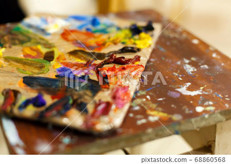 Close-up of an easel with paints, the artist Close-up of an easel with paints, the artist 68860568