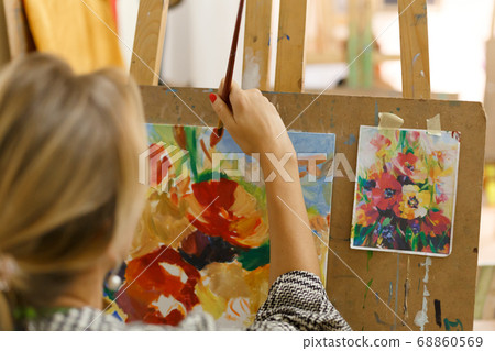 Close-up artist paints a picture on canvas with Close-up artist paints a picture on canvas with 68860569