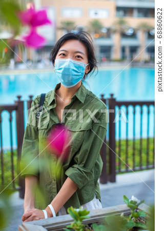 Asian woman wearing face mask in outdoors shopping 68860622
