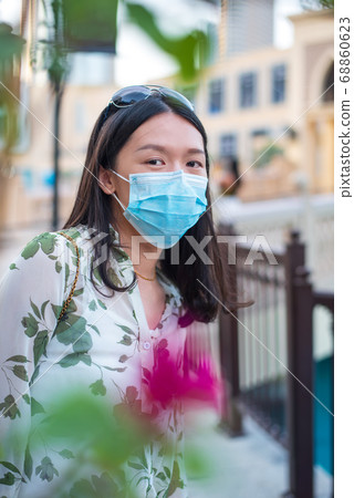 Asian woman wearing face mask in outdoors shopping 68860623
