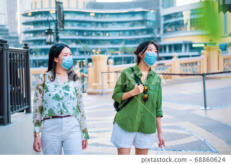 Two female friends Asian woman wearing face mask 68860624
