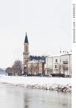 A mid winter view along the Salzach River in Salzburg, Austria looking towards the Protestant parish Salzburg Christ Church. 68860625