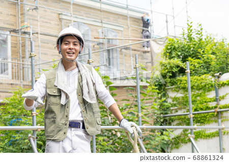 Young male worker working at a construction site Young male worker working at a construction site 68861324