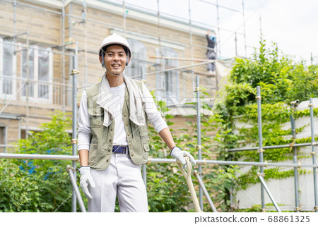Young male worker working at a construction site 68861325