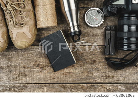 Mountain boots and hiking gear on wooden planks Mountain boots and hiking gear on wooden planks 68861862