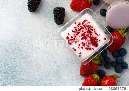Mousse dessert with berry topping on grey surface Mousse dessert with berry topping on grey surface 68862376