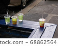 The storefront of a cafe in New York. Someone's ice tea. 68862564