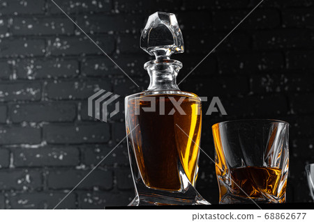 Whisky glass against dark black grunge wall Whisky glass against dark black grunge wall 68862677