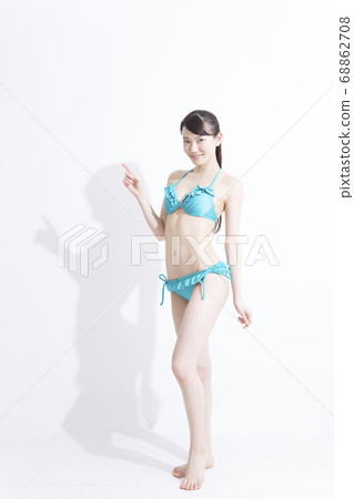 A woman in a swimsuit pointing 68862708