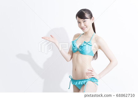 A woman in a swimsuit pointing 68862710