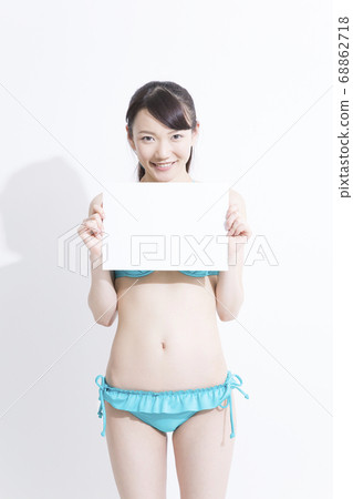 A woman in a swimsuit with a message board 68862718