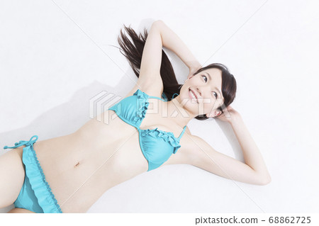 A woman in swimsuit lying down 68862725