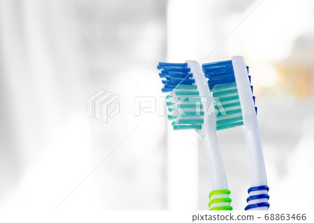 Close up photo of two new toothbrushes Close up photo of two new toothbrushes 68863466