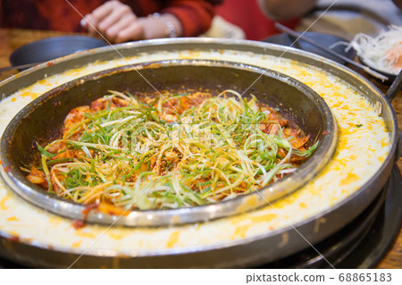 Woman eating Korean food cheese Dakgalbi Woman eating Korean food cheese Dakgalbi 68865183