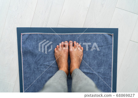 Yoga mat hot bikram yoga class - girl taking pov selfie of feet standing on towel in studio. Top view on floor 68869827