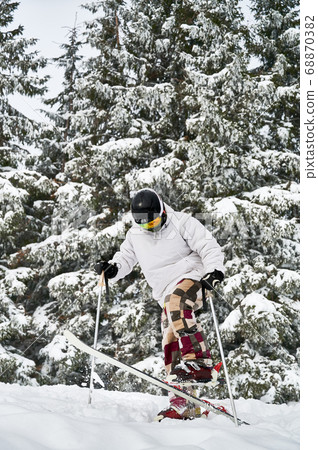 Winter kinds of sport. Skier doing tricks in the mountains in winter season Winter kinds of sport. Skier doing tricks in the mountains in winter season 68870382