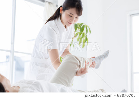 Medical physiotherapist and senior woman rehabilitating the foot Medical physiotherapist and senior woman rehabilitating the foot 68870703