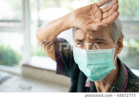 Sick asian senior woman touching her forehead,check the body temperature,illness and fever,tired,exhausted elderly patient wear a mask has flu and cold,infection symptoms of Coronavirus or Covid-19 Sick asian senior woman touching her forehead,check the body temperature,illness and fever,tired,exhausted elderly patient wear a mask has flu and cold,infection symptoms of Coronavirus or Covid-19 68872773