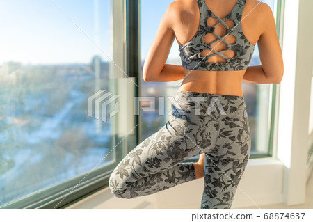 Yoga sunrise morning practice woman meditating. Tree pose wellness meditation Yoga sunrise morning practice woman meditating. Tree pose wellness meditation 68874637
